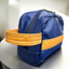 A blue upcycled toiletry bag with yellow pineapple-leather details.