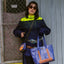 Young female posing with an upcycled tote bag and a sustainable Boruca small bag.