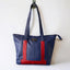 Wearsos blue and red tote bag hanging in the Wearsos workshop