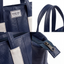 Wearsos Do Good Tote in navy blue upcycled leather with white accents, featuring detailed stitching and zipper pull.