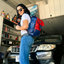 Wearsos Do Good backpack in red and blue upcycled aviation leather worn by a man in a white t-shirt and jeans