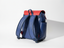 Wearsos Do Good upcycled backpack in navy blue and red with a minimalist design and adjustable shoulder straps.